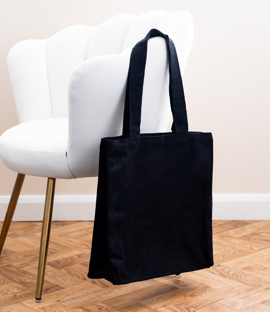 Personalised square canvas tote bag with internal pockets.